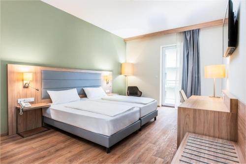 A bed or beds in a room at Akeah Verdi Budapest