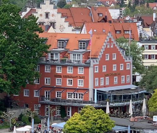 a large red building with a bunch of buildings at Hotel Lindauer Hof in Lindau