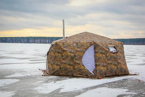 a tent sitting in the middle of a body of water at Aurora Tent Camp in Karasjok