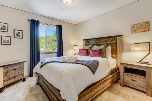 a bedroom with a large bed and a window at Crystal Retreat Cabin - Hot Tub BBQ Eco Escape in Florissant