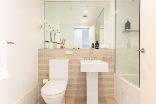 a bathroom with a toilet and a sink at MadeComfy Executive & Stylish Inner-City Apartment in Sydney