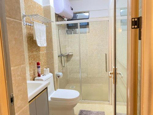 a bathroom with a shower and a toilet and a sink at Cozy Haven in Nairobi