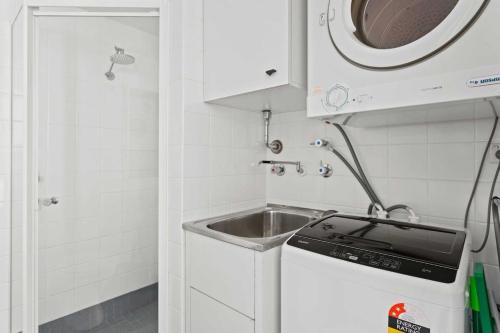 a small kitchen with a sink and a microwave at Idyllic Studio by University Campuses in Sydney