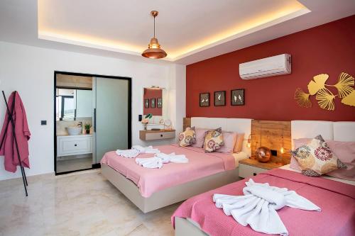 a bedroom with two beds with towels on them at Tashan Villas in Kas
