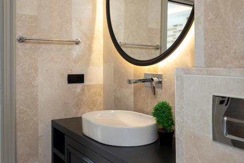 a bathroom with a sink and a mirror at Tashan Villas in Kas