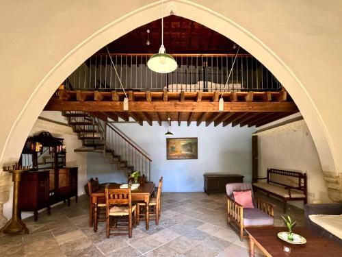 an archway in a room with a table and chairs at Porfyrios Country House in Chirokitia