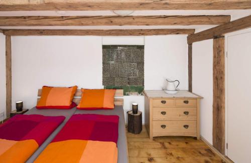 a bedroom with a bed and a dresser in it at Fewo Titisee im Kaspershäusle in Altglashütte