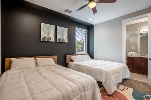 a bedroom with two beds and a mirror at Spacious 3 Bed House near MD Anderson with Free Parking & Wi-Fi in Houston