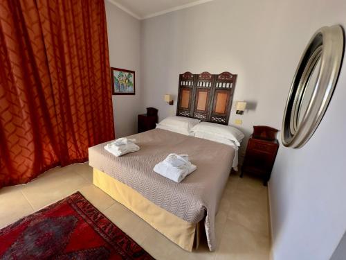 a bedroom with a bed with towels on it at Arts Club Suite & Spa in Chianciano Terme