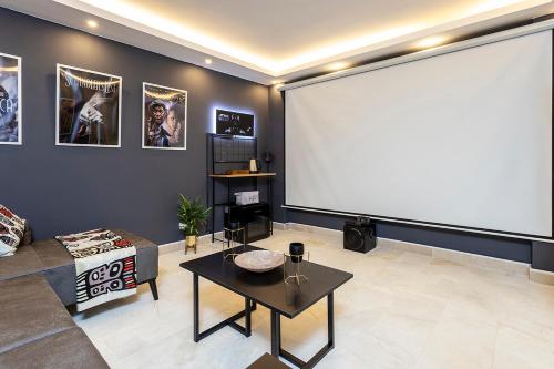a living room with a large screen in the wall at Tashan Villas in Kas