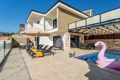 a house with a swimming pool with a pink inflatable swan at Tashan Villas in Kas