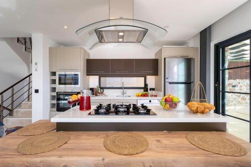 a kitchen with a stove and a counter top at Tashan Villas in Kas