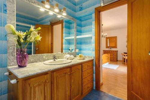 La salle de bains est pourvue d'un lavabo et d'un miroir. dans l'établissement Villa Claudia - Ibiza, à Sant Rafael de Sa Creu