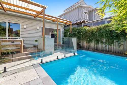 a swimming pool in the backyard of a house at Sophisticated 2-Bed House with a Pool in Seddon