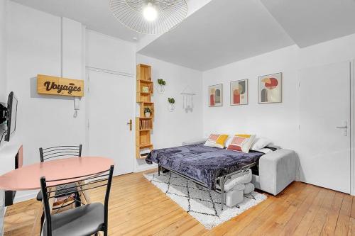 une pièce avec un lit et une table dedans dans l'établissement Joli studio rénové avec terrasse, à Toulouse