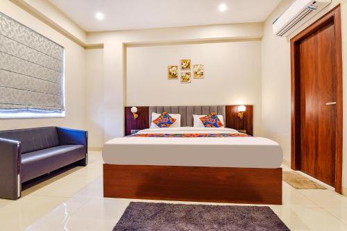 a bedroom with a bed and a couch at FabHotel Pravaasam Residency in Jaipur