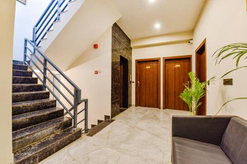 a staircase in a house with a couch at FabHotel Pravaasam Residency in Jaipur