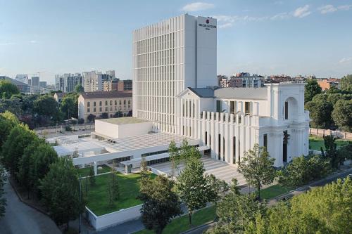 an aerial view of a large white building in a city at NH Collection Milano CityLife in Milan