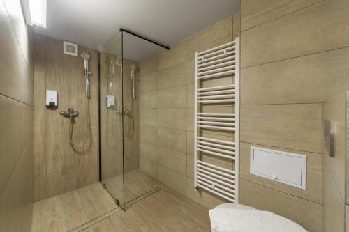 a bathroom with a shower with a glass door at Eden 1 & Eden 2 in Predeal