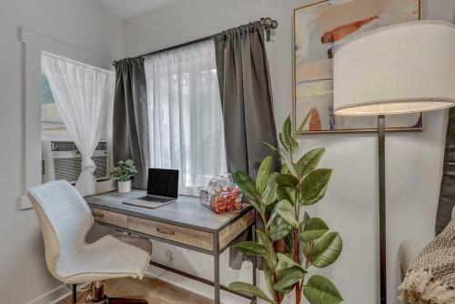 a desk with a laptop computer on it in front of a window at Euro Villa - Walkable Location Scenic Views in Colorado Springs