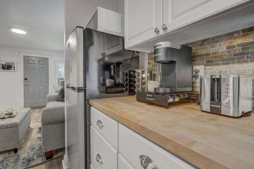 a kitchen with a refrigerator and a stove at Euro Villa - Walkable Location Scenic Views in Colorado Springs