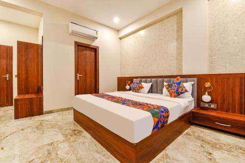 a bedroom with a large bed in a room at FabHotel Pravaasam Residency in Jaipur