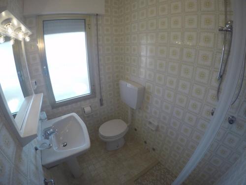 a bathroom with a toilet and a sink and a shower at Residence Zenith in Caorle