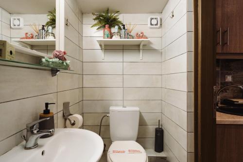 a bathroom with a toilet and a sink at Lef Apartment in Thessaloniki
