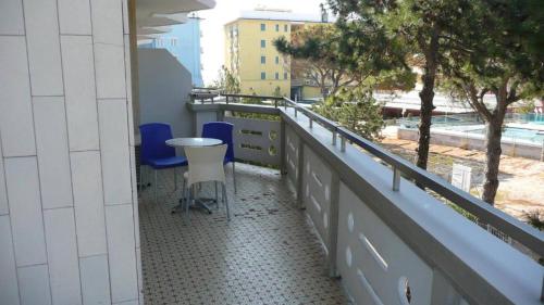 a balcony with two chairs and a table on it at Residence Zenith in Caorle