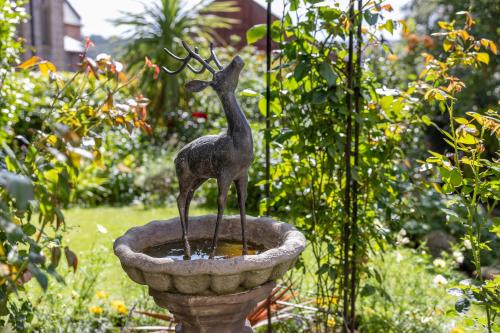 a statue of a bird in a bird bath at Highgate House in Whitby