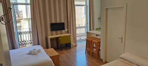 TV a/nebo společenská místnost v ubytování Hotel San Lorenzo Boutique