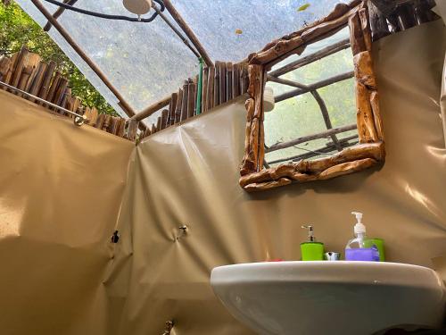 a bathroom with a sink and a mirror at Tiret Riverside Resort and Retreat in Eldoret