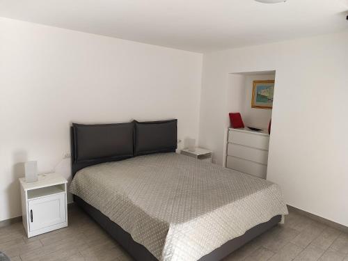 a bedroom with a bed and two night stands at La balconata sul mare in Giovinazzo