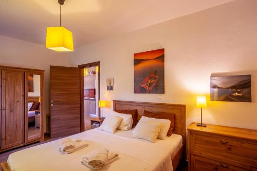 two beds in a bedroom with two lamps at The Garden Villa Hanioti in Hanioti