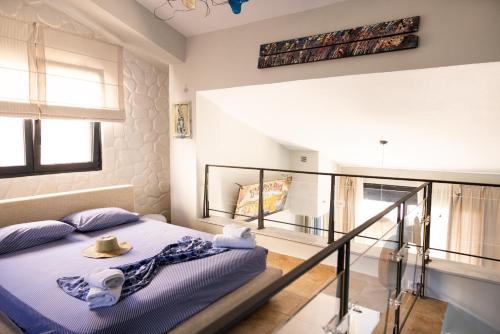 a bedroom with a bed with a hat on it at Pelagos Paradise Seafront Villa by Booking Kottas in Kalamitsi