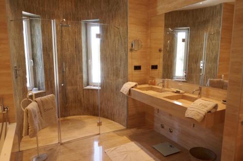 a bathroom with a glass shower and a sink at Villa Dream - Santa Eulalia in Cala Llonga