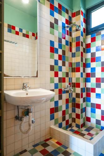 a bathroom with a sink and a shower at Pelagos Paradise Seafront Villa by Booking Kottas in Kalamitsi