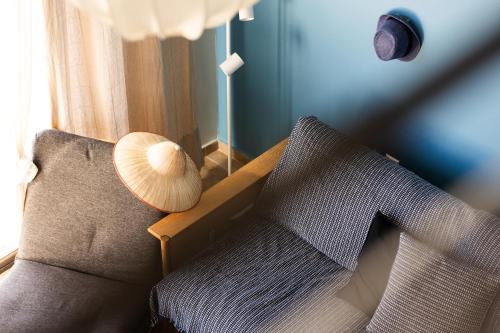 a living room with a couch and a lamp at Pelagos Paradise Seafront Villa by Booking Kottas in Kalamitsi