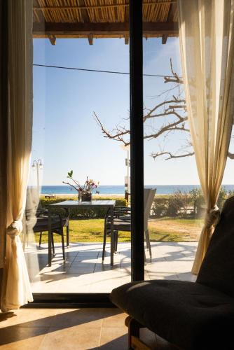 a living room with a view of the ocean at Pelagos Paradise Seafront Villa by Booking Kottas in Kalamitsi
