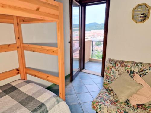 a living room with a couch and a window at La Terrazza in Villasimius