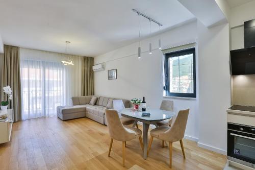 a living room with a table and a couch at Apartments Centar Montesun in Budva