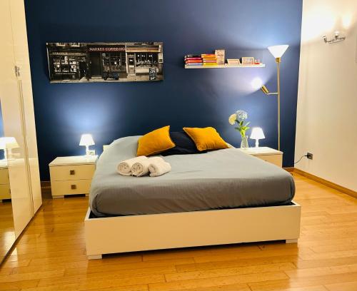 a bedroom with a bed with yellow pillows at Chiara Guest House - Nuova Metro blu in Milan