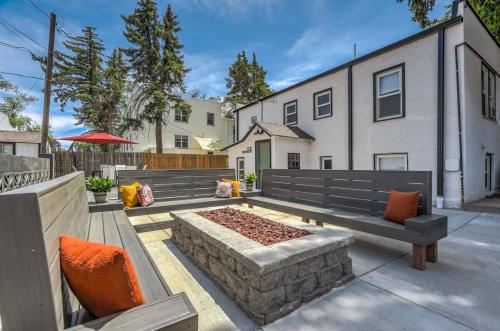 a patio with a bench and orange chairs and a building at Pikes Divine - Prime Spot BBQ Fire Pit Alfresco in Colorado Springs