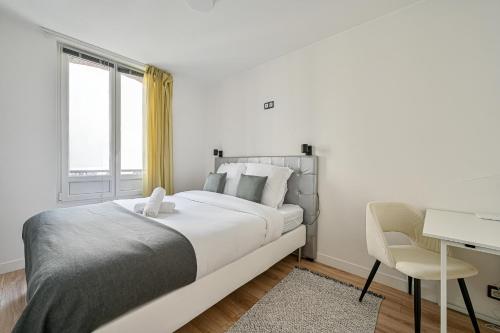 a white bedroom with a bed and a desk and a window at L'Edificio - Paris Disney - 5 chambres - 12p in Champs-sur-Marne