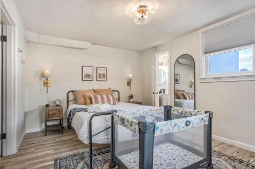a bedroom with a bed and a table in it at Pikes Divine - Prime Spot BBQ Fire Pit Alfresco in Colorado Springs
