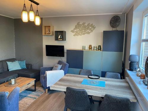 a living room with a table and a couch at Ostseeapartment Allee Strandpark in Niendorf