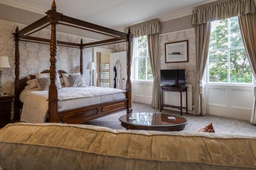 a bedroom with a canopy bed and a coffee table at Highgate House in Whitby
