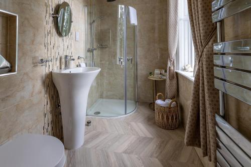 a bathroom with a sink and a shower at Highgate House in Whitby