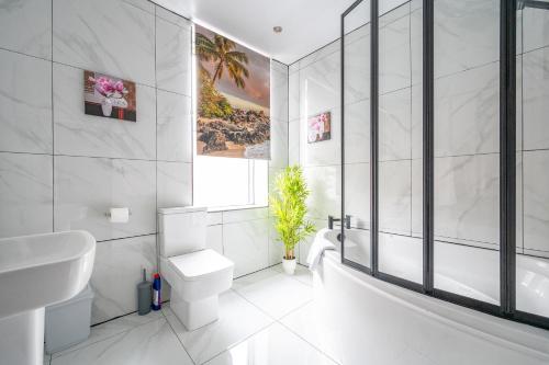 a white bathroom with a toilet and a sink at *RB10W* For your most relaxed & Cosy stay + Free Parking + Free Fast WiFi * in Belle Isle