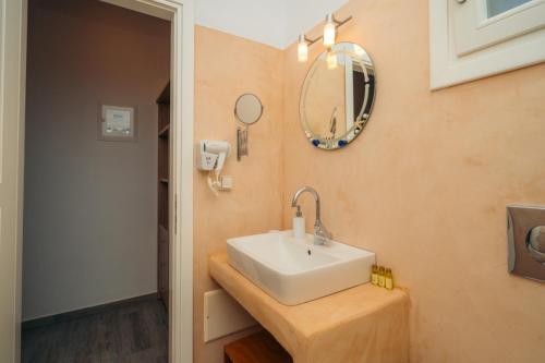 a bathroom with a sink and a mirror on the wall at Arhontou in Apollonia